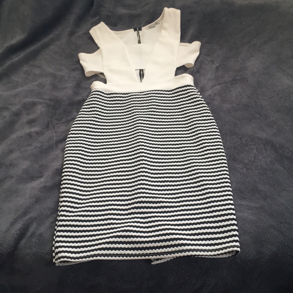Selling a cream, and black knee length dress.